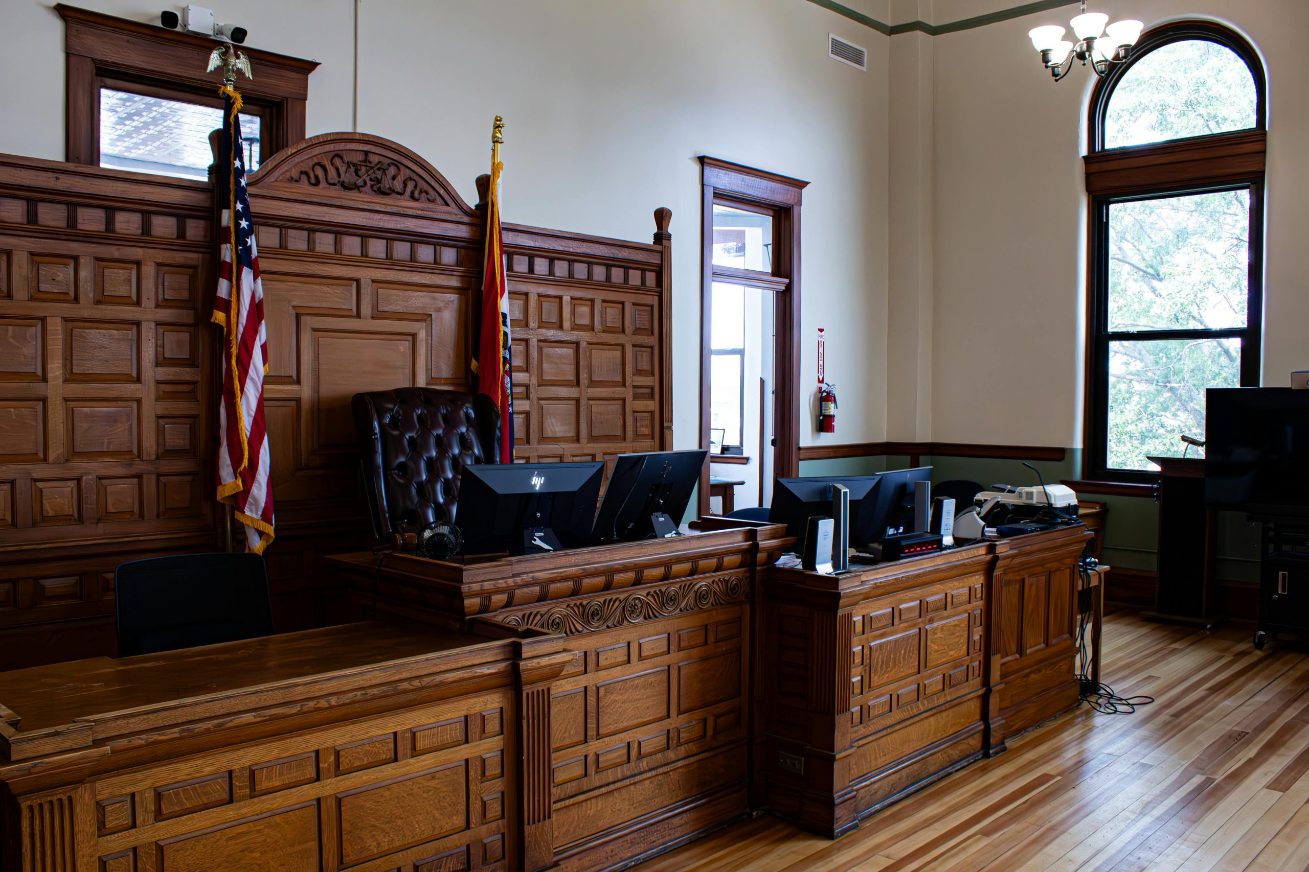 courtroom with two US flags in the middle